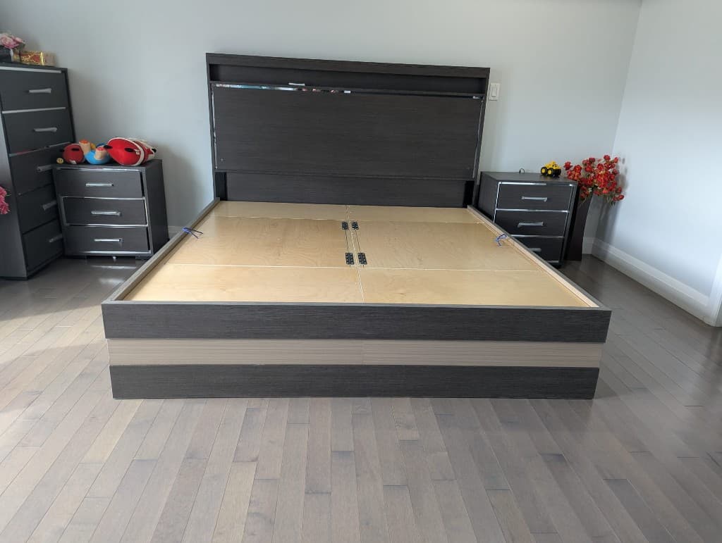 Custom grey storage box bed with mirrored headboard panel and matching nightstands