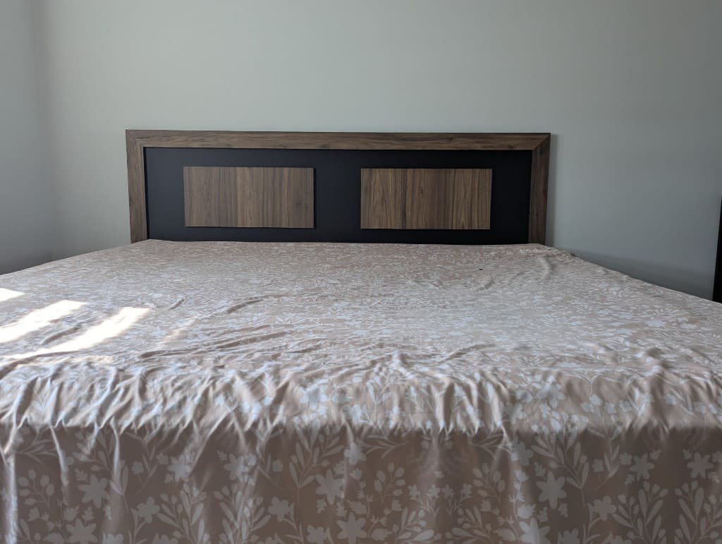 Modern custom bed with a two-tone headboard and built-in LED accent lighting