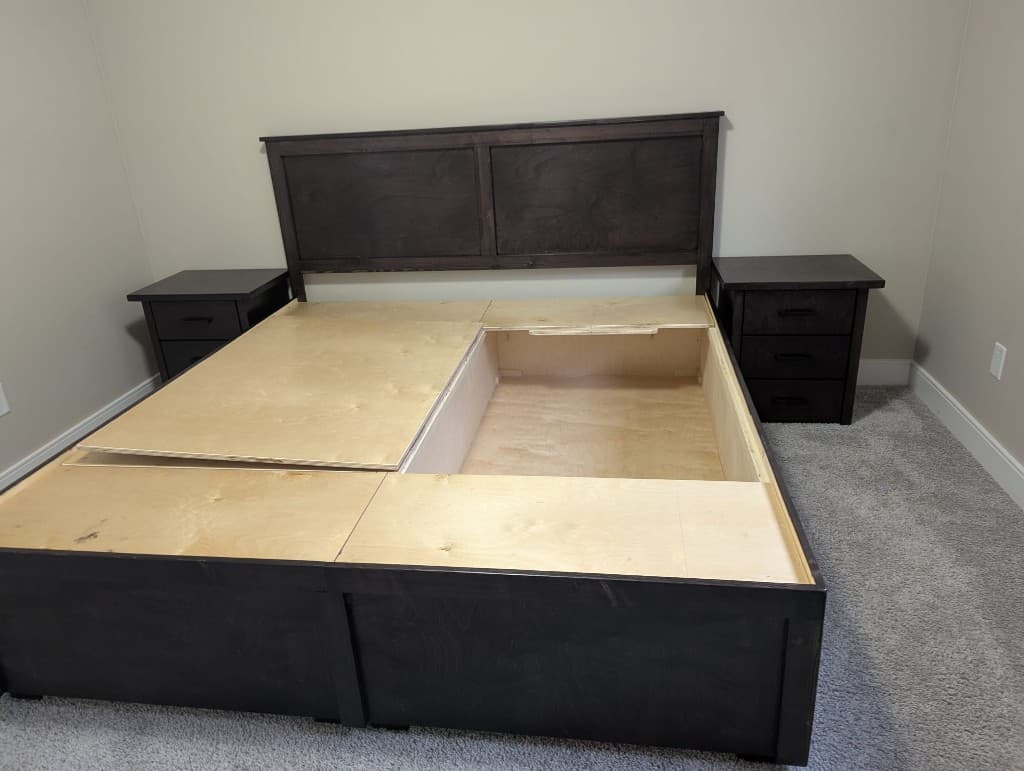 Custom storage box bed with the lid open, revealing built-in under-bed storage