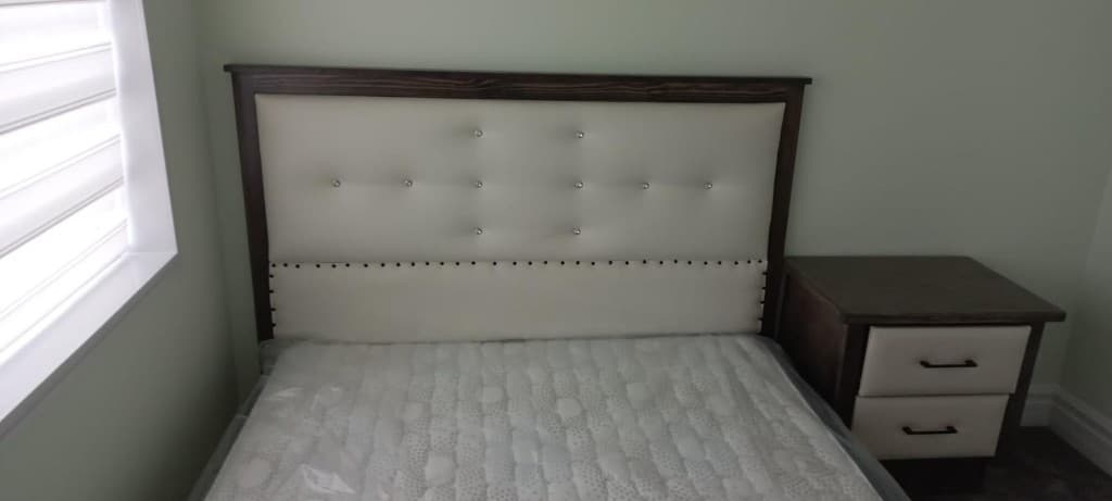 Custom tufted cream headboard installed with mattress in an Edmonton bedroom