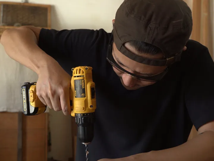 Home Solution Services handyman fixing kitchen cabinets in an Edmonton home — we fix it, you relax